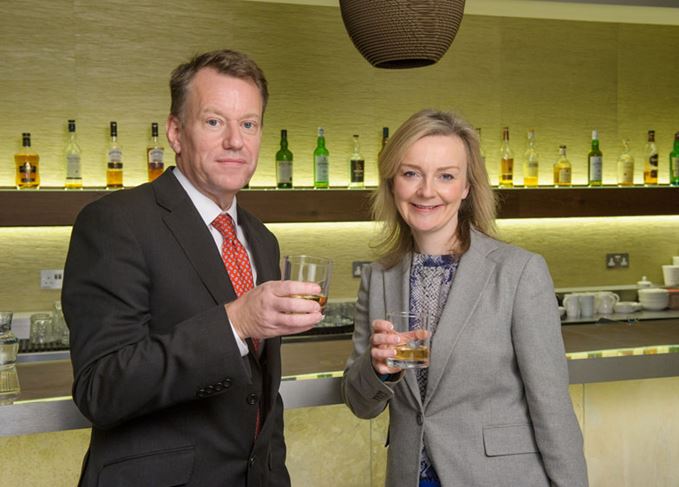 David Frost, CEO of the SWA, toasts the opening of the organisation's new London office with Environment Secretary Elizabeth Truss. David Frost and Elizabeth Truss