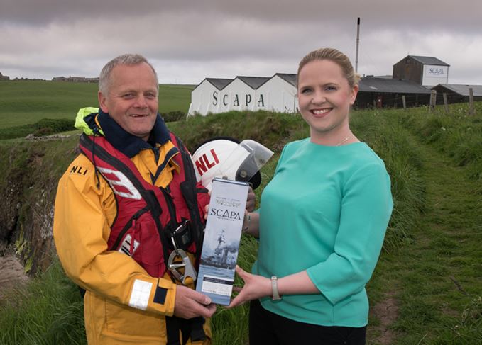 Graham Campbell of the RNLI Lifeboat crew Scapa distillery manager Nicola Stevenson present Scapa Jutland Scapa Jutland